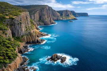 Dramatic cliffs rising from the turquoise ocean in tasmania, australia