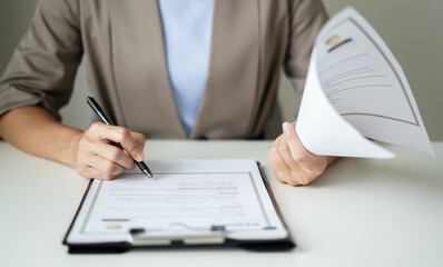 Business woman employer holding resume hiring recruit looking cv resume to hire candidates, analyzing information before job interview. Recruitment concepts