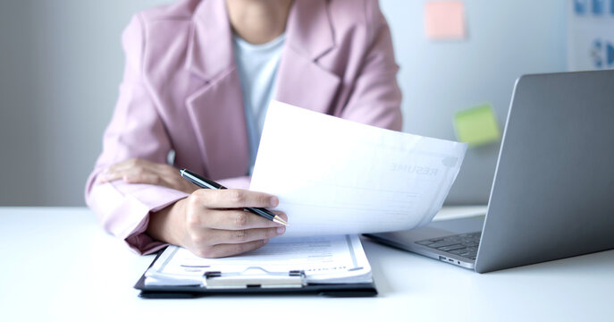 Business woman employer holding resume hiring recruit looking cv resume to hire candidates, analyzing information before job interview. Recruitment concepts