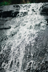 Captivating Waterfall Flowing Over Rocky Surface in Natural Setting