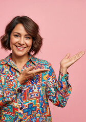 Smiling Young Woman Presenting with Hands on Pink Background