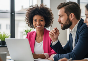 Diverse Business Colleagues Collaborating on Laptop in Office