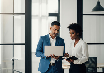 Business Colleagues Collaborating on Laptop in Modern Office