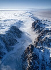 High-altitude view of snowy mountains and clouds