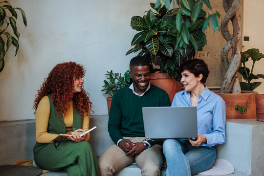 Business people working together on a project using laptop in modern office