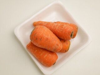 Baby carrots on white tray