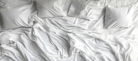 Close Up View of an Unmade Cozy White Bed with Pillows and Crumpled Sheets in Modern Bedroom