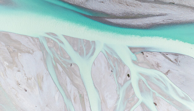 Iconic Italian river Tagliamento, Friuli, Carnia, Italy. Aerial view shows braided river channels with turquoise water flowing through gravel beds.