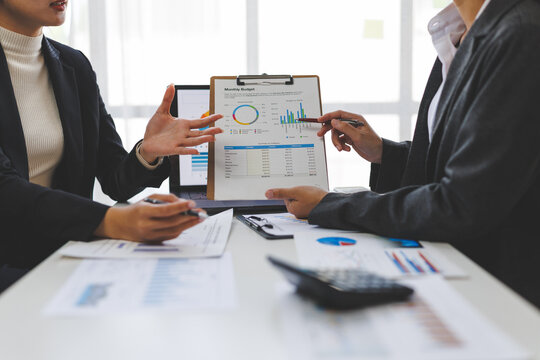 Business people analyzing financial charts and graphs at meeting