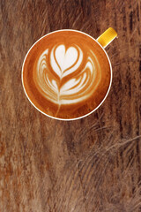  a cup of latte art coffee on wooden background                                                                                                                                                         