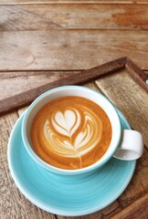  a cup of latte art coffee on wooden background                                                                                                                                                         