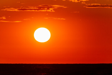 Beautiful sunset sky with orange and red hues over the calm Baltic Sea.