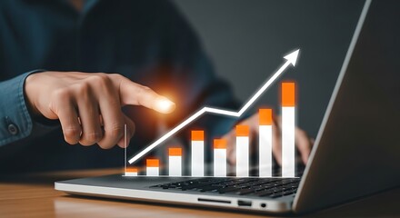 Businessman analyzing upward trending financial growth chart on laptop screen