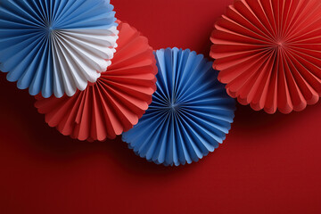 Colorful patriotic paper fan decorations create festive red white blue display.