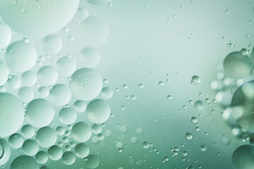 Close-up abstract macro of floating oil and water bubbles with creamy essence textures on soft gradients. Ideal for skincare, design, or wellness content.