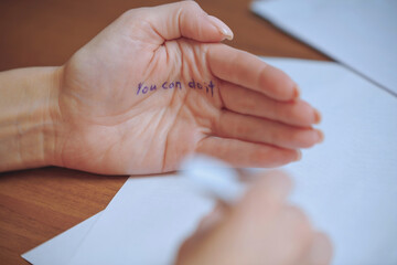 Hand with motivational message written on palm close up