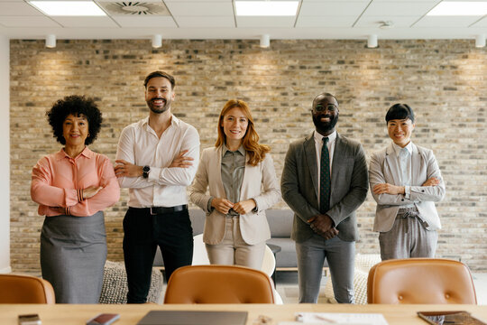 Confident business team smiling in modern office portrait