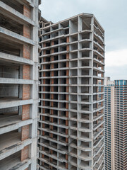 Unfinished High-Rise Building Showcasing the Raw Structure of Construction, Incomplete Skyscraper Revealing the Ongoing Process of Urban Development