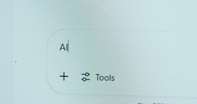 Close-up of a chat interface showing &ldquo;AI&rdquo; and a tools icon, indicating that artificial intelligence features are enabled and ready to assist the user.