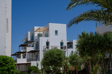 Modern white villas in a quiet residential complex near the Mediterranean Sea on Cyprus.