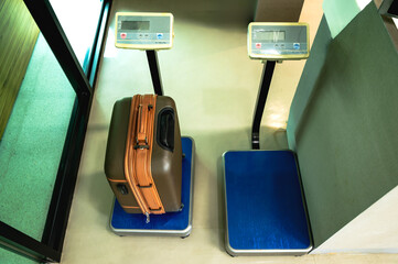 Top view passenger luggage weighting on weigh machine in airport security check