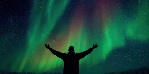 Northern Lights with Silhouette of Man Celebrating under Aurora Sky
