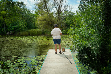 woman on the dock fishing, overgrown lake, fishing
