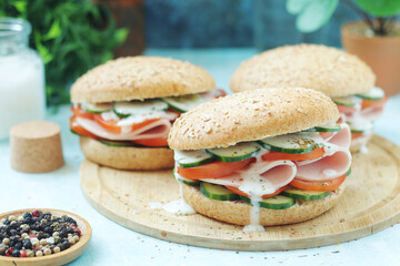 Bun sandwiches with salami and vegetables	