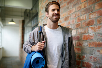 Smile, man and bag for fitness at gym for yoga class, instructor and ready for training. Happy, male person and lobby with equipment for morning lesson, pilates membership and start for wellness