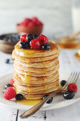 Pancakes with berries in rustic style