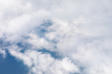Aerial perspective of a cloudy sky, highlighting the vastness of the atmosphere. Drift across a deep blue sky, creating a serene and tranquil scene