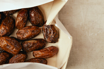 Dried dates on sale at outdoor farmer market. The fruit shrinks during this process, leaving a small, energy-dense dried fruit. Organic produce. Close up. Part of the series