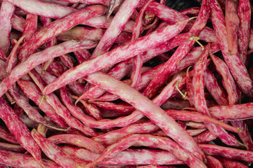 Fresh string beans at small local urban market. Organic produce on sale at outdoor farmer market. Selling fresh crops and veggies harvest. European urban setting. Close up. Part of the series