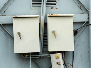 Close-up of an old locomotive and old carriages on a decommissioned railway, the paint cracked, peeled and rusted.