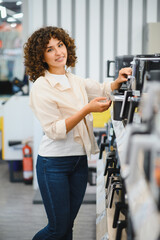 Customer choosing coffee machine in electronics store