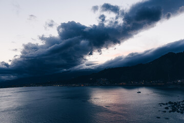 Storm Clouds Over Coastal Town at Dusk