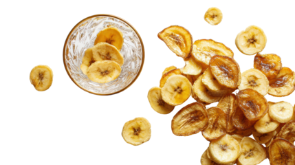 Dried banana chips scattered around a glass bowl with some chips inside on a white isolate background.