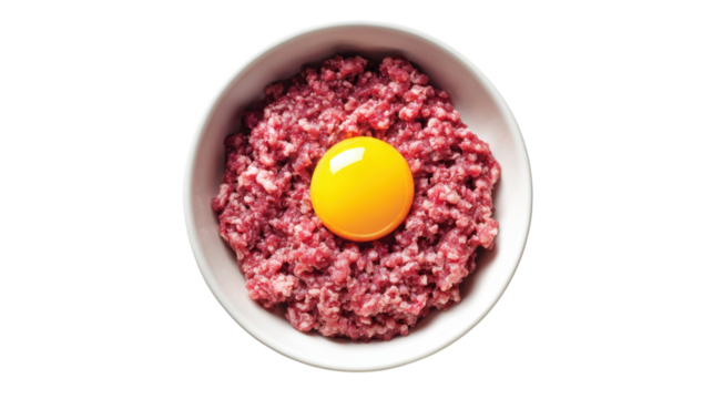 Raw minced meat with a fresh egg yolk in a bowl, ideal for culinary recipes.