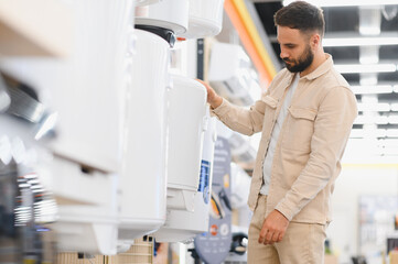 Fototapeta premium Customer choosing water heater in electronics store