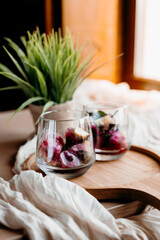 Blackcurrant lemonade with herbs and orange — vibrant, juicy, and bursting with summer energy. Served in clear glasses on a wooden tray.