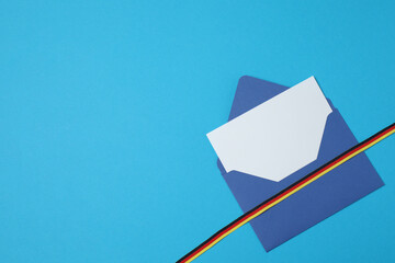 blue envelope with ribbon on a blue background
