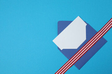 blue envelope with ribbon on a blue background
