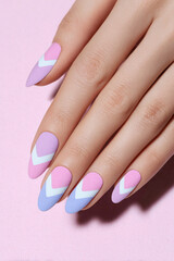 Creative pastel nail art featuring geometric patterns in soft hues showcasing elegance and fashion