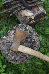 chop wood. the axe lies on a wooden block in the yard