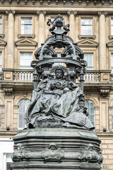 Extravagant bronze statue of Queen Victoria in St. Nicholas' Square. The figure of the elderly Queen Victoria is seated on the throne with an elaborate canopy on a Pink granite base is by the sculptor