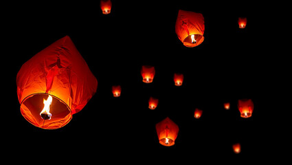 Red lanterns floating in dark sky lantern fire