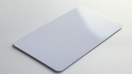 Blank white plastic card on textured white surface
