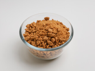 Biscuits crumble in a glass bowl on white background