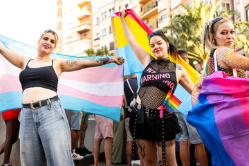 Activists holding transgender and intersex flags at pride parade