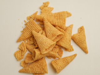 Crunchy snacks piled on white background